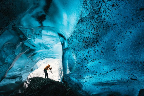 Wednesday 25th November 2015, Vatnajökull national park, Iceland: Photographer Mikael Buck with assistance from renowned local Icelandic guide Einar Runar Sigurdsson, explored the frozen world of Vatnajökull glacier in Iceland using Sonys world first back-illuminated full-frame sensor  which features in the ?7R II camera. His images were taken without use of a tripod or any image stitching techniques in photoshop. This was made possible through Sonys new sensor technology, allowing incredibly detailed low-light hand held photography. Previously images this detailed would have required carrying bulky equipment to the caves, some of which can require hiking and climbing over a glacier for up to two hours to to access. This picture: Inside the &#039;ABC cave&#039; - which stands for Amazing Blue Cave.  Guide Einar Runar Sigurdsson is seen taking a photo at the entrance to the cave PR Handout - editorial usage only. Photographer&#039;s details not to be removed from metadata or byline. For further information please contact Rochelle Collison at Hope & Glory PR on 020 7014 5306 or rochelle.collison@hopeandglorypr.com Copyright: © Mikael Buck / Sony 07828 201 042 / mikaelbuck@gmail.com