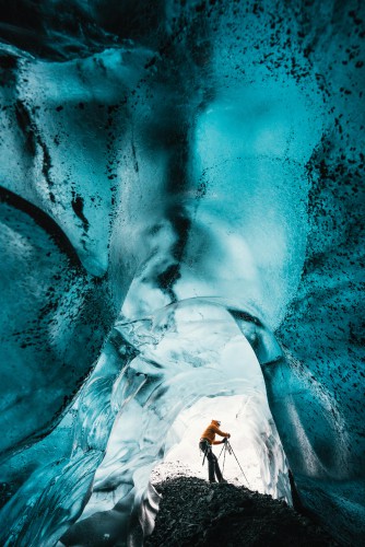 Wednesday 25th November 2015, Vatnajökull national park, Iceland: Photographer Mikael Buck with assistance from renowned local Icelandic guide Einar Runar Sigurdsson, explored the frozen world of Vatnajökull glacier in Iceland using Sonys world first back-illuminated full-frame sensor  which features in the ?7R II camera. His images were taken without use of a tripod or any image stitching techniques in photoshop. This was made possible through Sonys new sensor technology, allowing incredibly detailed low-light hand held photography. Previously images this detailed would have required carrying bulky equipment to the caves, some of which can require hiking and climbing over a glacier for up to two hours to to access. This picture: Inside the &#039;ABC cave&#039; - which stands for Amazing Blue Cave.  Guide Einar Runar Sigurdsson is seen taking a photo at the entrance to the cave PR Handout - editorial usage only. Photographer&#039;s details not to be removed from metadata or byline. For further information please contact Rochelle Collison at Hope & Glory PR on 020 7014 5306 or rochelle.collison@hopeandglorypr.com Copyright: © Mikael Buck / Sony 07828 201 042 / mikaelbuck@gmail.com